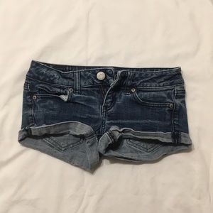 Dark wash denim shorts.